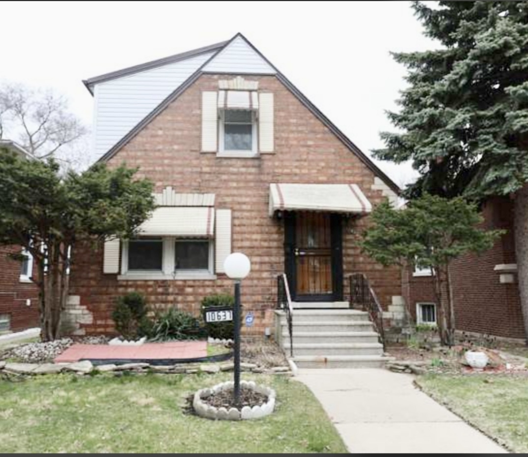 10637 South Normal Avenue Chicago, IL 60628 - Photo 1 of 8 a front view of a house with garage