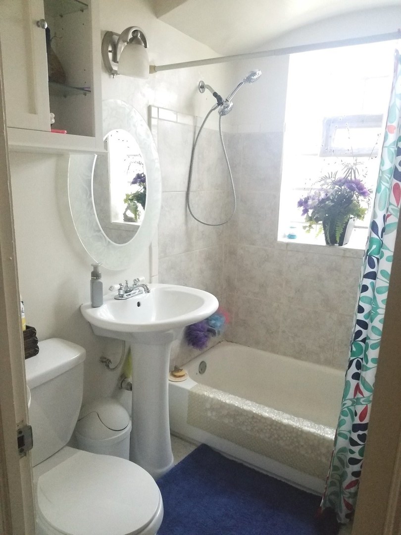 10637 South Normal Avenue Chicago, IL 60628 - Photo 6 of 8 a bathroom with a sink toilet and shower
