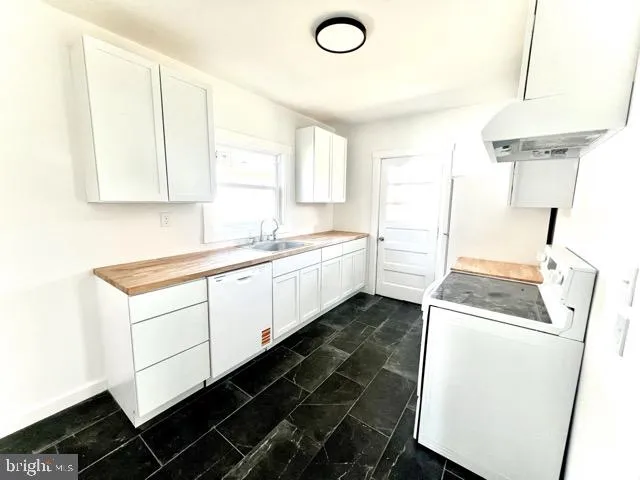 a utility room with sink dryer and washer