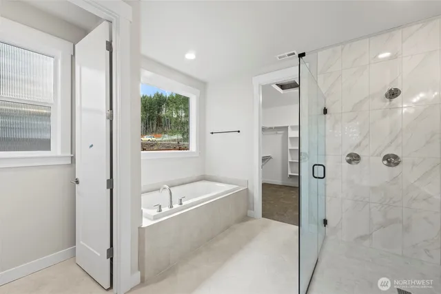 a bathroom with a bathtub shower and a sink