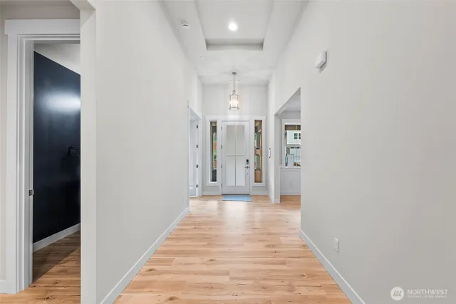 a view of a hallway with wooden floor