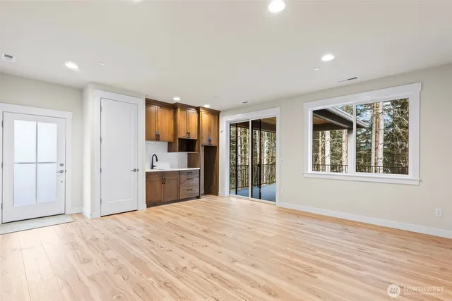 a view of a kitchen with wooden floor and a window