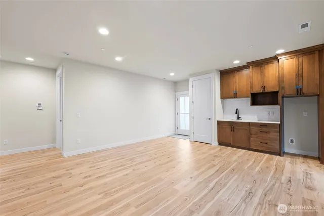 a large kitchen with kitchen island a sink stainless steel appliances and cabinets