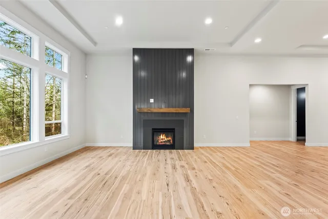 a view of an empty room with window and fire place