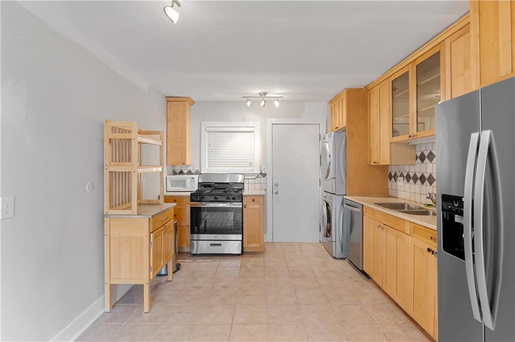 866 Briarcliff Road Northeast, Unit B3 Atlanta, GA 30306 - Photo 4 of 17 a kitchen with stainless steel appliances granite countertop a refrigerator stove and oven