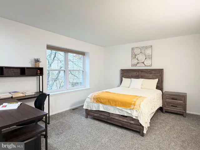 a bedroom with a bed and a window