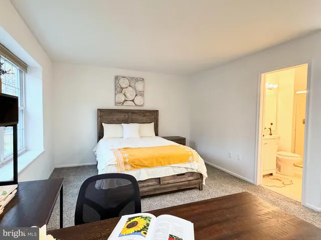 a bedroom with bed and wooden floor