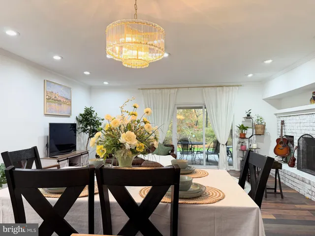 a view of a dining room with furniture and chandelier