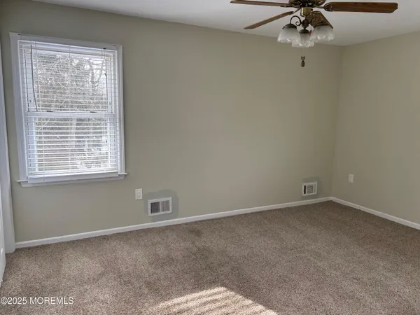 a view of a street with wooden fence