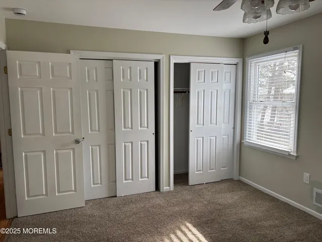a view of a livingroom with an empty space and a window