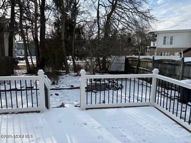 a view of a street with wooden fence