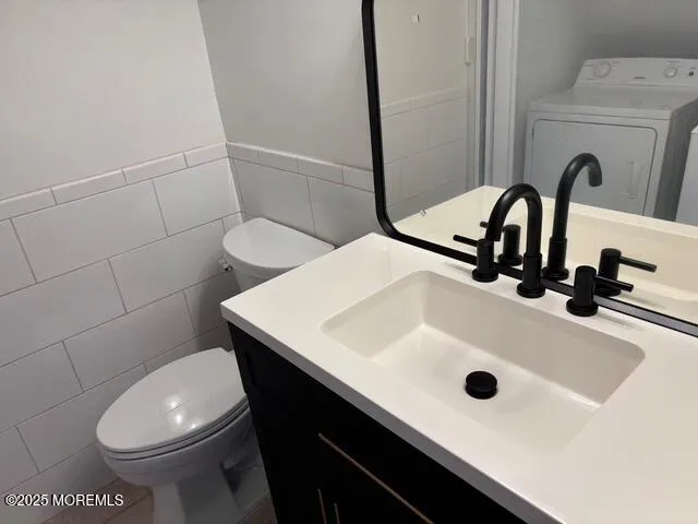 a bathroom with a sink a toilet and a mirror