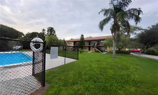 a front view of a house with garden and plants
