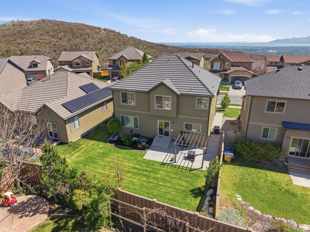 2007 Fielding Hill Lane Draper, UT 84020 - Photo 56 of 83 Rear exterior featuring a spacious lawn, extended patio with a pergola, and mature landscaping