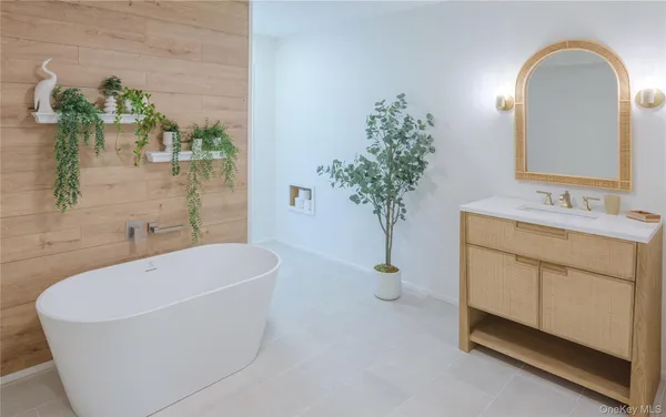 a bathroom with a bathtub a sink and a mirror
