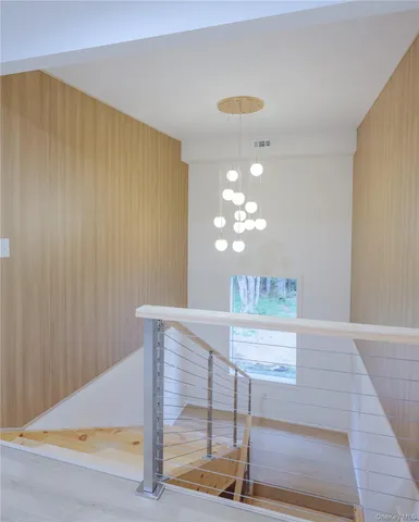 a view of a hallway with chandelier