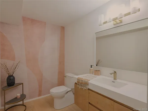 a bathroom with a sink a toilet and mirror