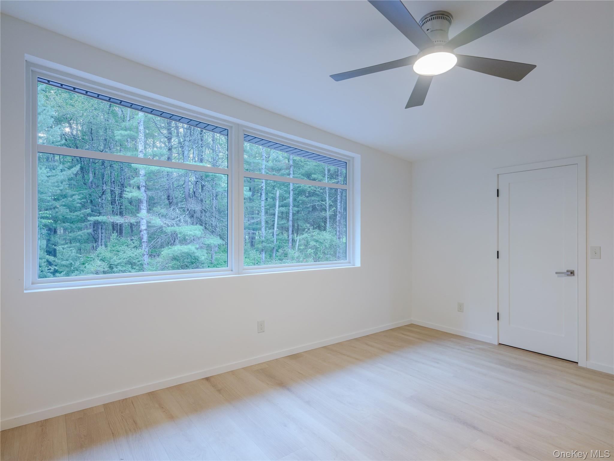 233 Goldsmith Road Jeffersonville, NY 12748 - Photo 23 of 30 an empty room with a window and a ceiling fan