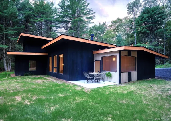 a front view of house with yard and seating area