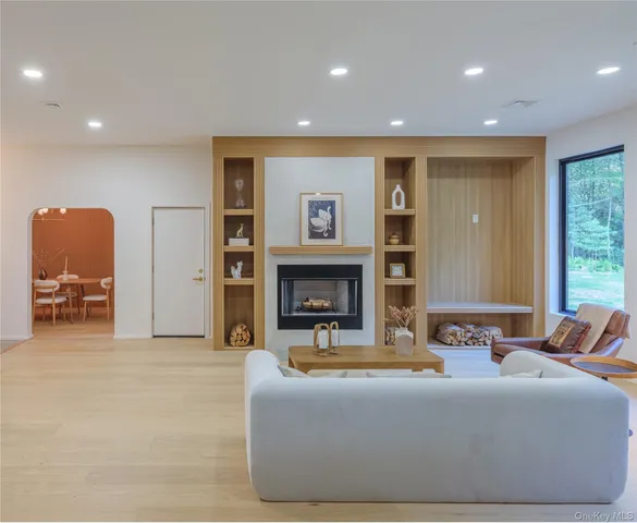 a living room with fireplace furniture and a window