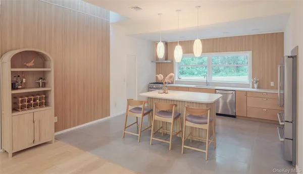 a dining room with a window and chairs