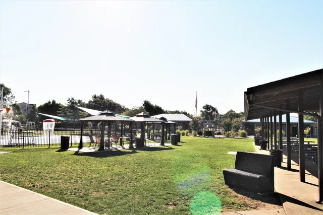 a view of a house with a yard and sitting area