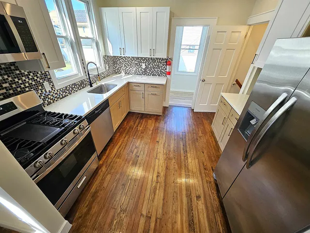 a kitchen with wooden floors and a stove