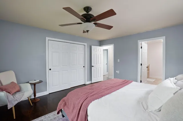 a bedroom with a bed and a chair