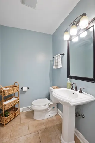 a bathroom with a sink toilet and a mirror