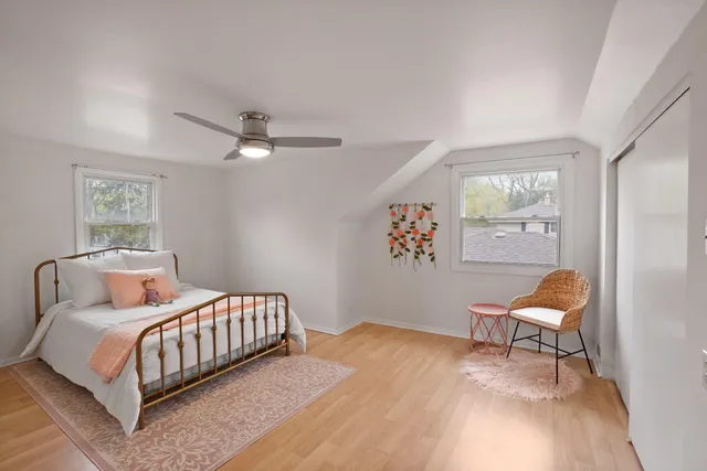 a bedroom with a bed and a chair