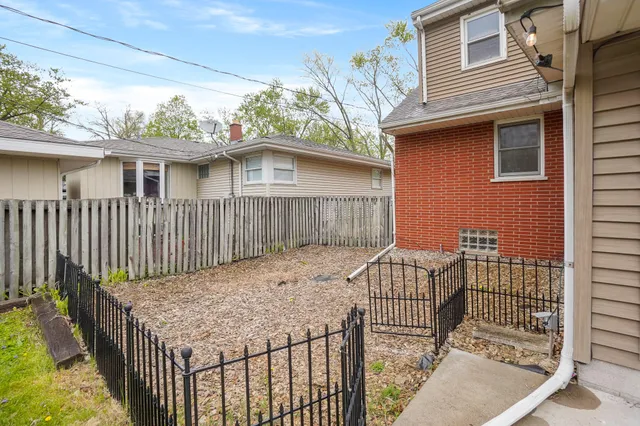 a view of a house with wooden fence