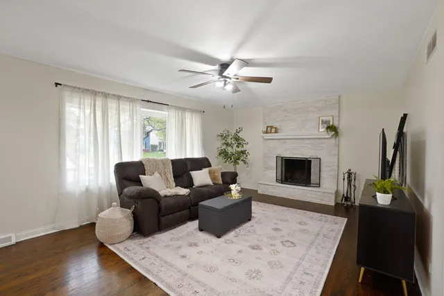 a living room with furniture a fireplace and a flat screen tv