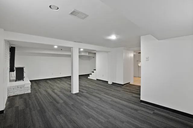 a view of a room with wooden floor