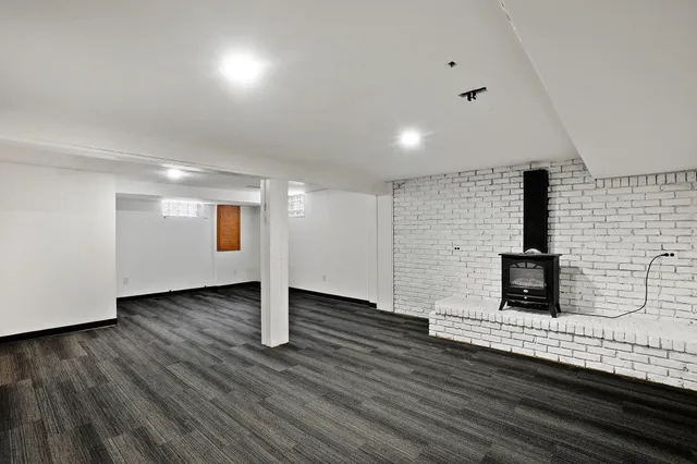 a view of a livingroom with an empty space and wooden floor
