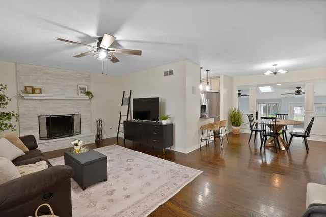 a living room with furniture a fireplace and a flat screen tv