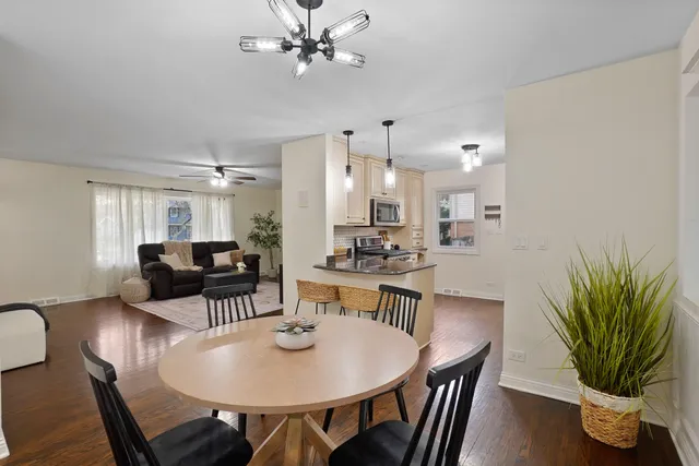 a view of a dining room with furniture and wooden floor