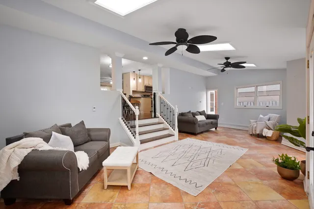 a living room with furniture and a chandelier