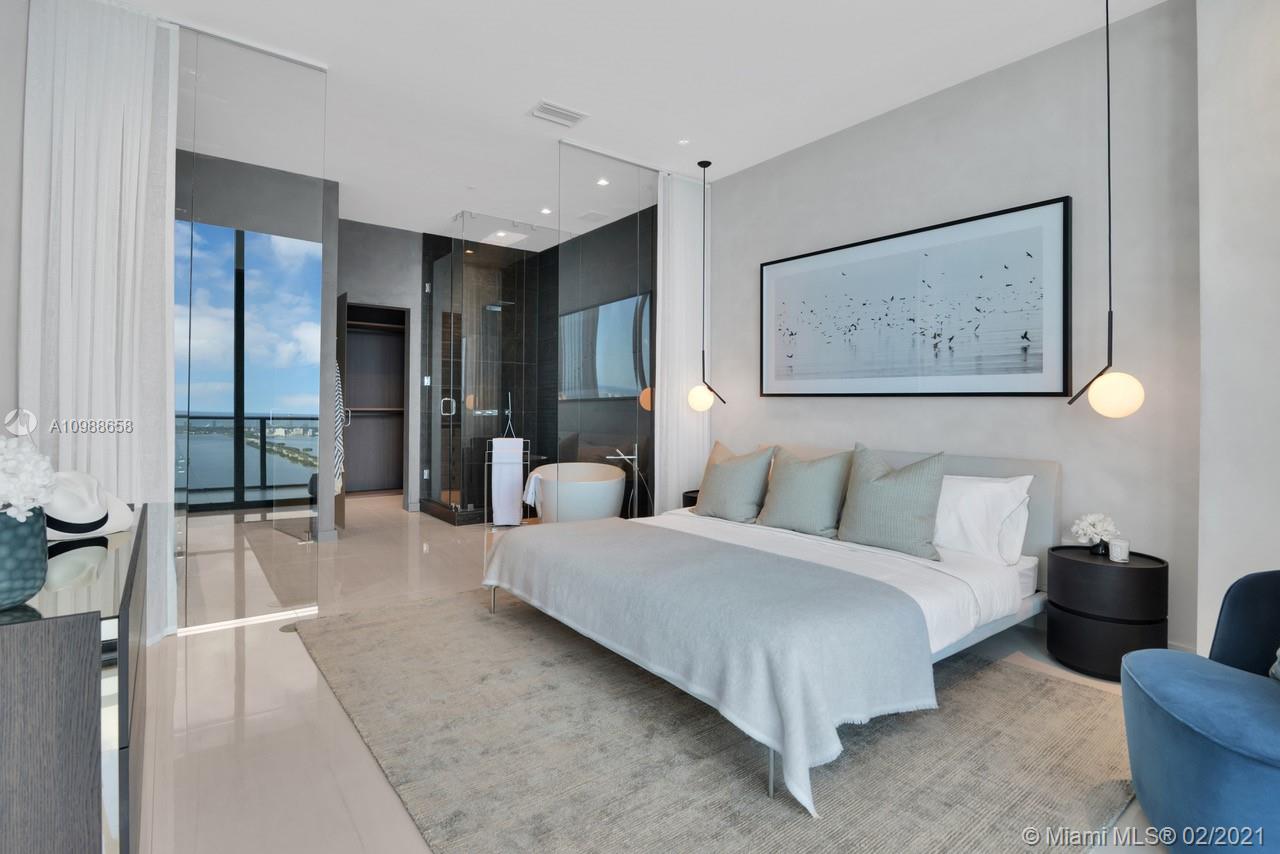 480 Northeast 31st Street, Unit PH5402 Miami, FL 33137 - Photo 13 of 35 a spacious bedroom with a bed a couch and painting on the wall