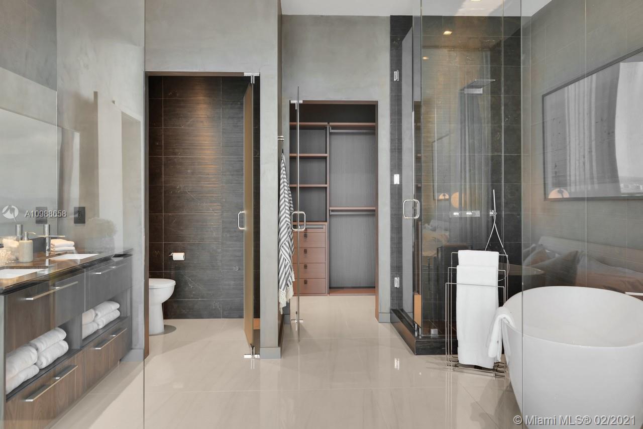 480 Northeast 31st Street, Unit PH5402 Miami, FL 33137 - Photo 16 of 35 a bathroom with a tub and shower