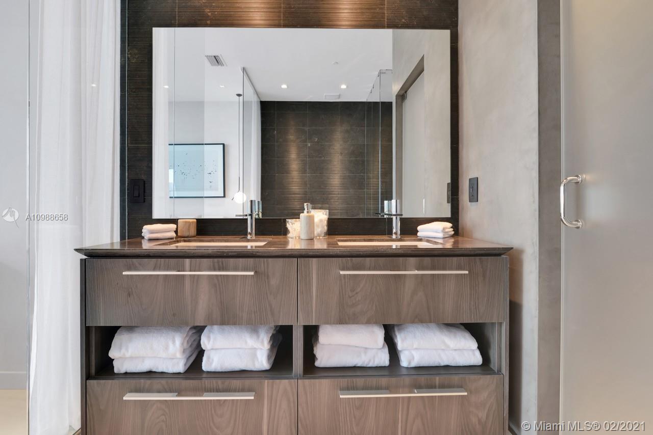 480 Northeast 31st Street, Unit PH5402 Miami, FL 33137 - Photo 17 of 35 a bathroom with a sink and a mirror