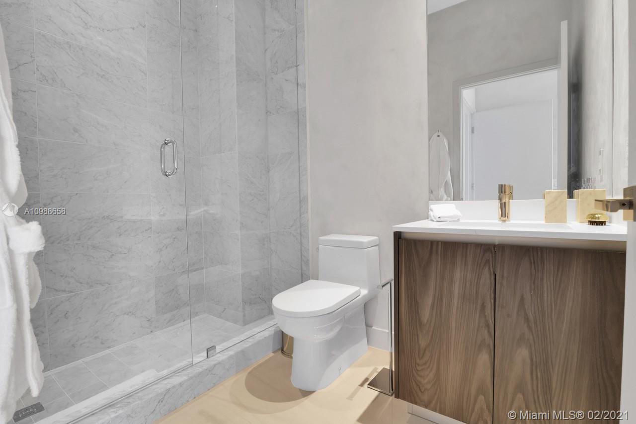 480 Northeast 31st Street, Unit PH5402 Miami, FL 33137 - Photo 21 of 35 a bathroom with a sink toilet and a mirror