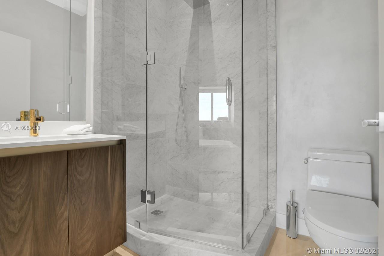 480 Northeast 31st Street, Unit PH5402 Miami, FL 33137 - Photo 22 of 35 a bathroom with a sink a toilet and shower