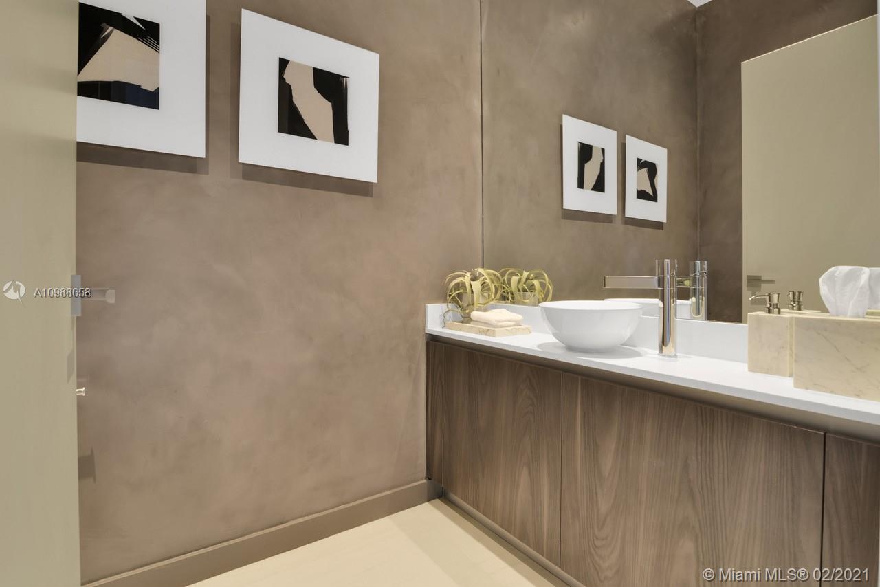 480 Northeast 31st Street, Unit PH5402 Miami, FL 33137 - Photo 23 of 35 a bathroom with a sink and a mirror