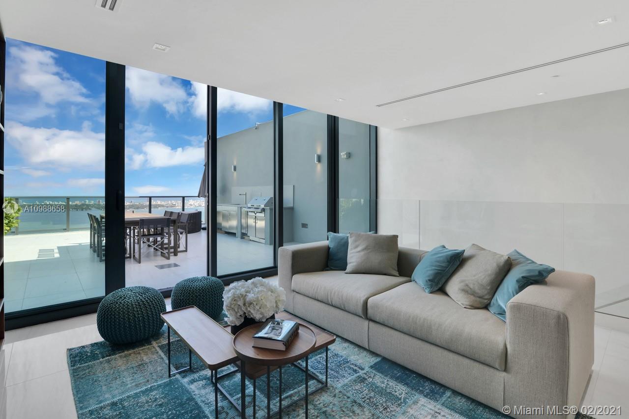 480 Northeast 31st Street, Unit PH5402 Miami, FL 33137 - Photo 24 of 35 a living room with furniture and a floor to ceiling window