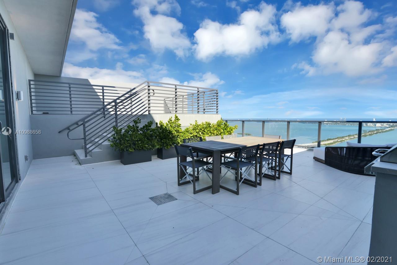 480 Northeast 31st Street, Unit PH5402 Miami, FL 33137 - Photo 25 of 35 a view of a dinning tables and chairs in the terrace