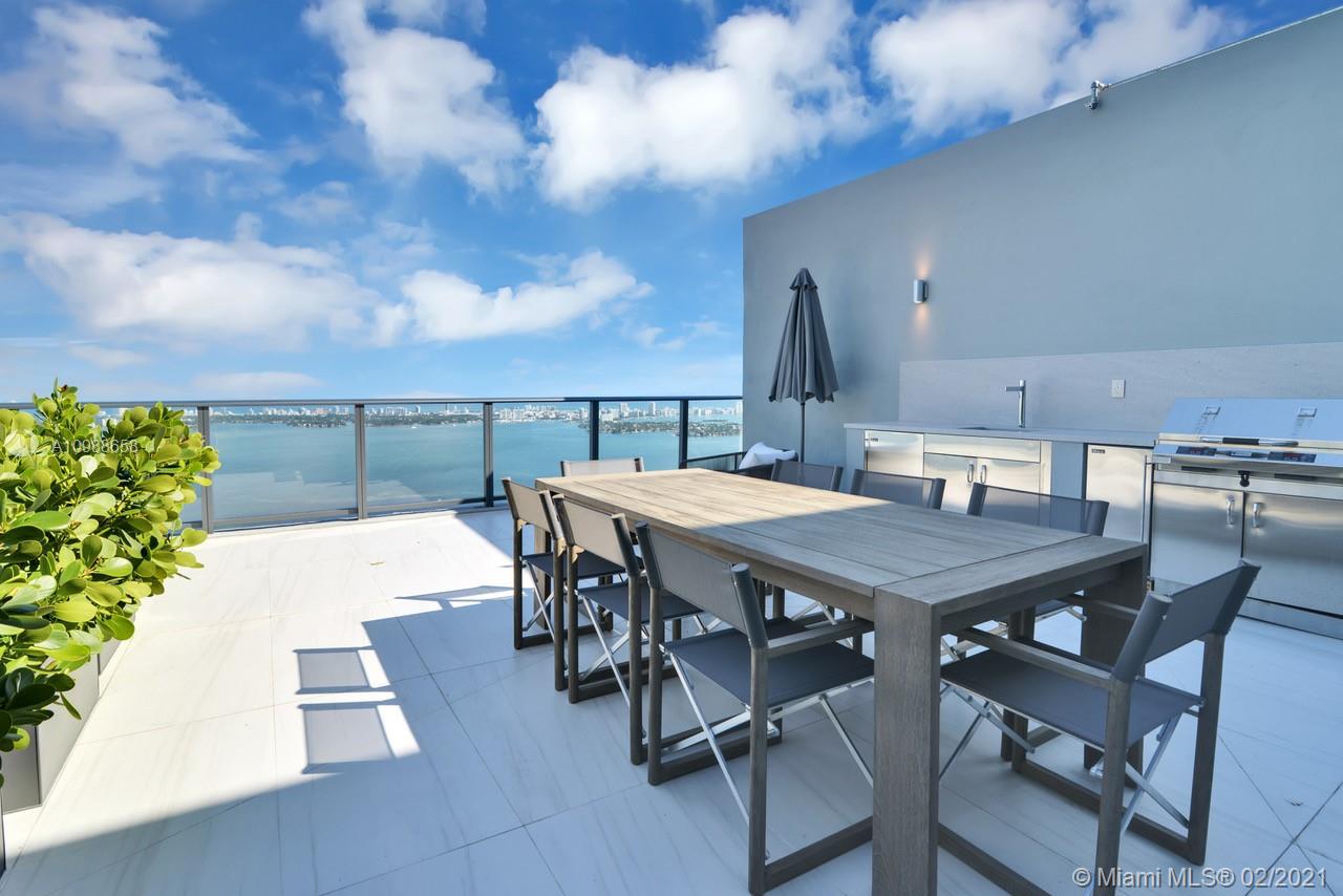 480 Northeast 31st Street, Unit PH5402 Miami, FL 33137 - Photo 26 of 35 a view of a dinning table and chairs in the patio