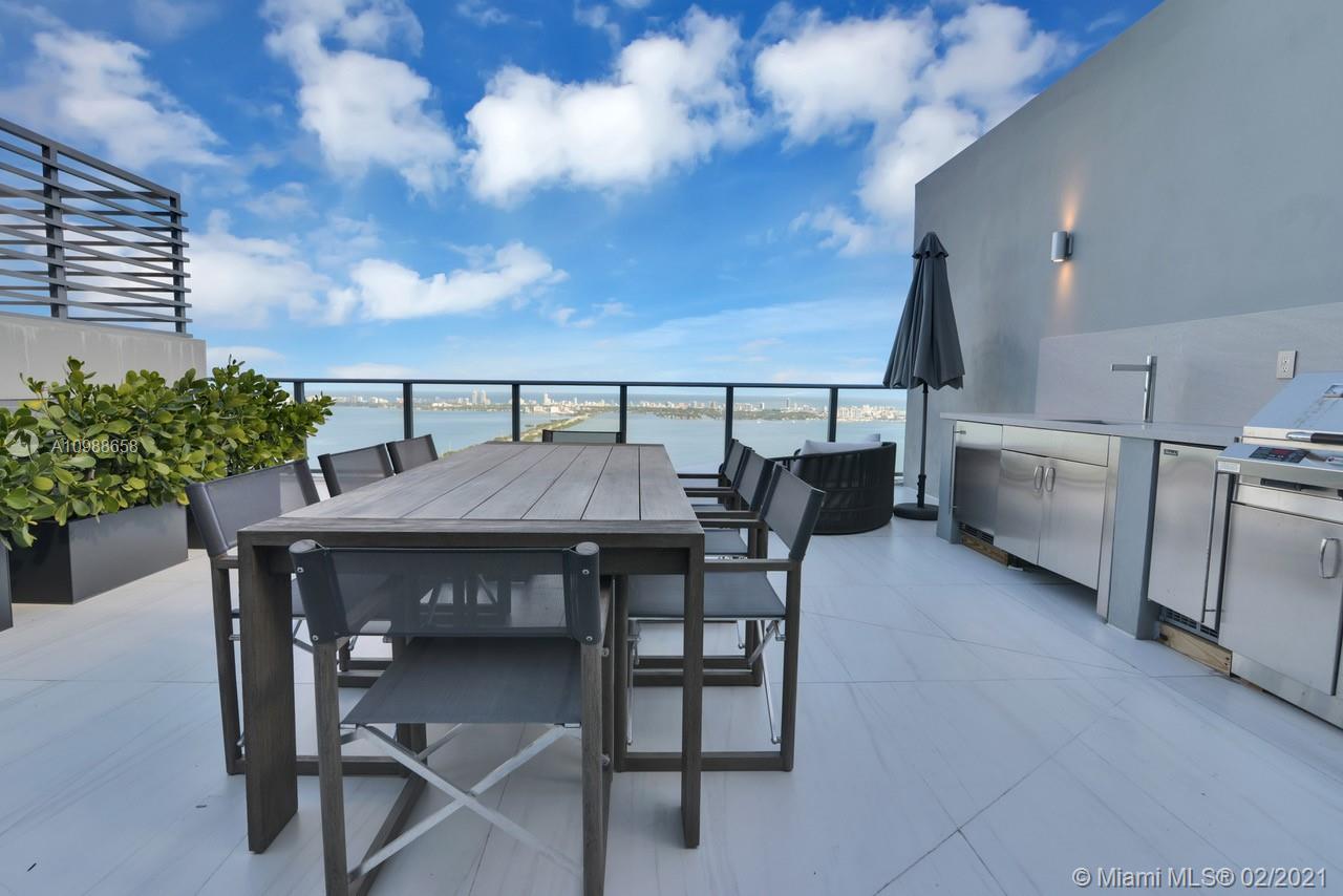 480 Northeast 31st Street, Unit PH5402 Miami, FL 33137 - Photo 27 of 35 a view of a dinning table and chairs in the patio
