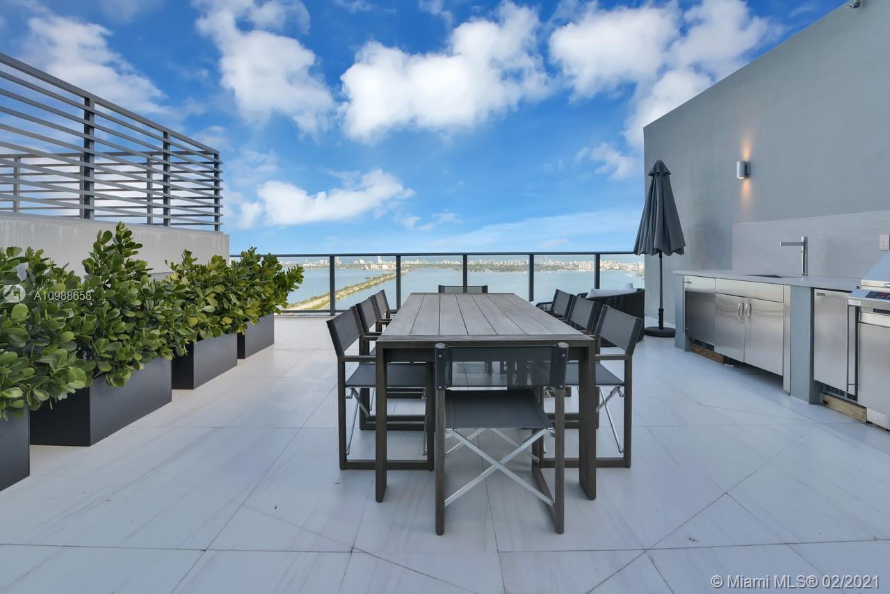 480 Northeast 31st Street, Unit PH5402 Miami, FL 33137 - Photo 29 of 35 a view of a dinning table and chairs in patio