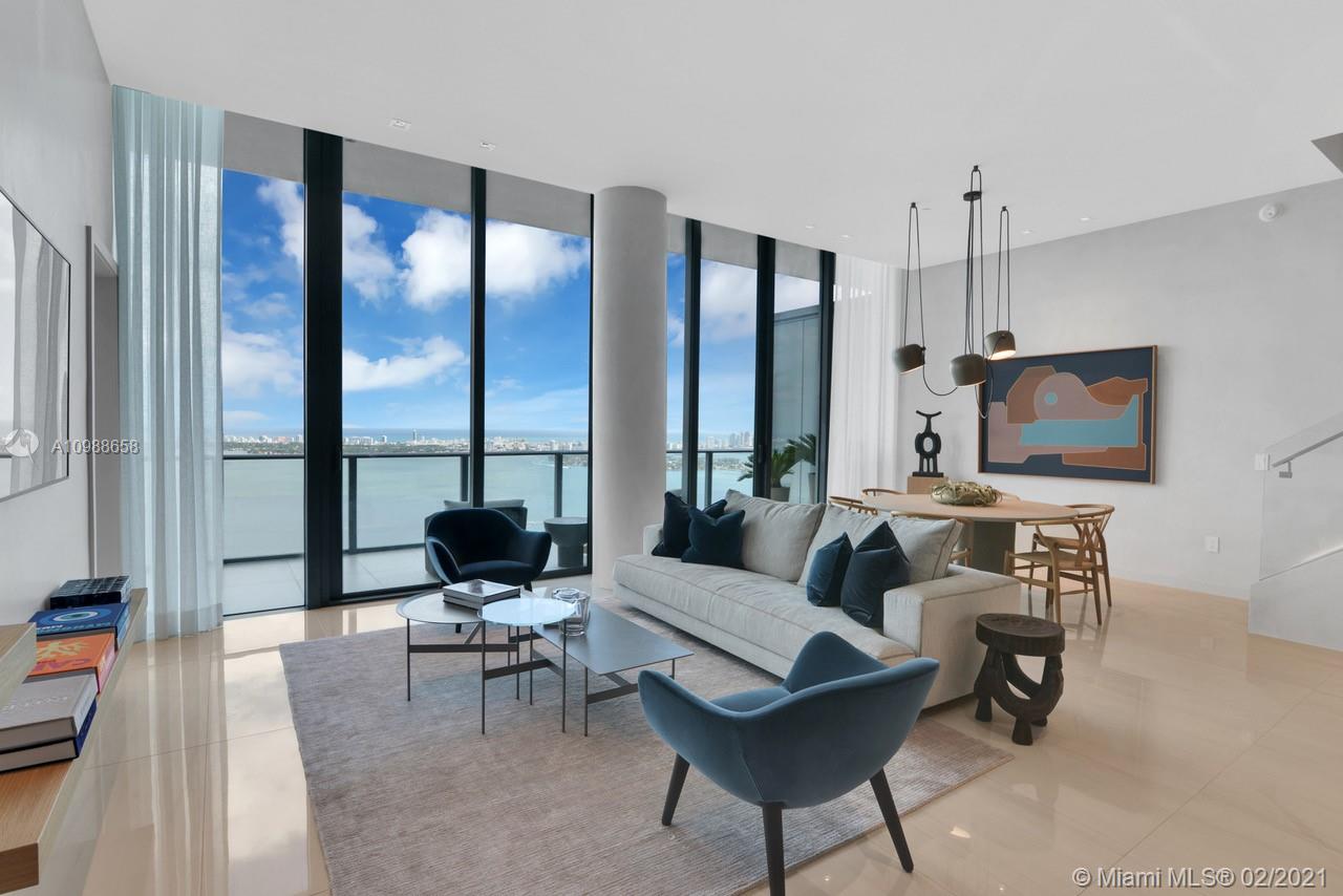 480 Northeast 31st Street, Unit PH5402 Miami, FL 33137 - Photo 4 of 35 a living room with furniture and a flat screen tv