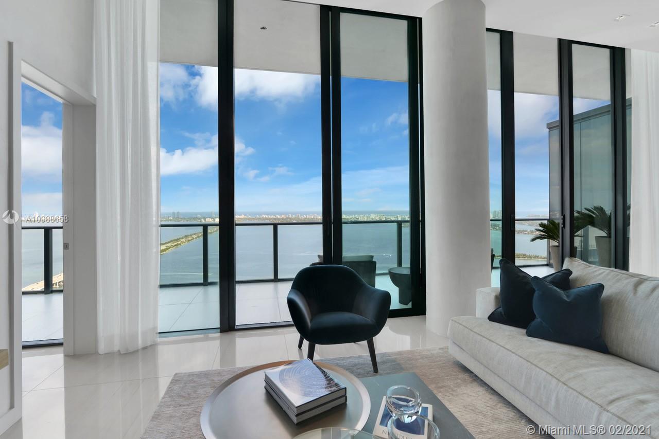 480 Northeast 31st Street, Unit PH5402 Miami, FL 33137 - Photo 6 of 35 a living room with furniture and a large mirror next to a window